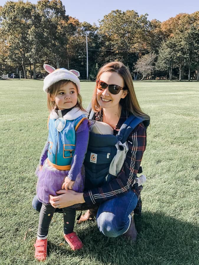 Mother wearing newborn in an Ergo Baby Omni 360 in Cool Air Mesh with her toddler